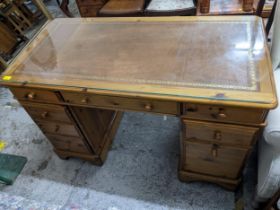 A modern pine twin pedestal desk with eight drawers, inset leather scriber and glass top, 76cm x
