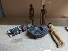 A group of African tribal art carved wooden figures and a bowl to include a painted light wood