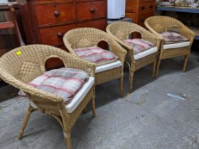 Four wicker work armchairs with loose cushion seats Location: