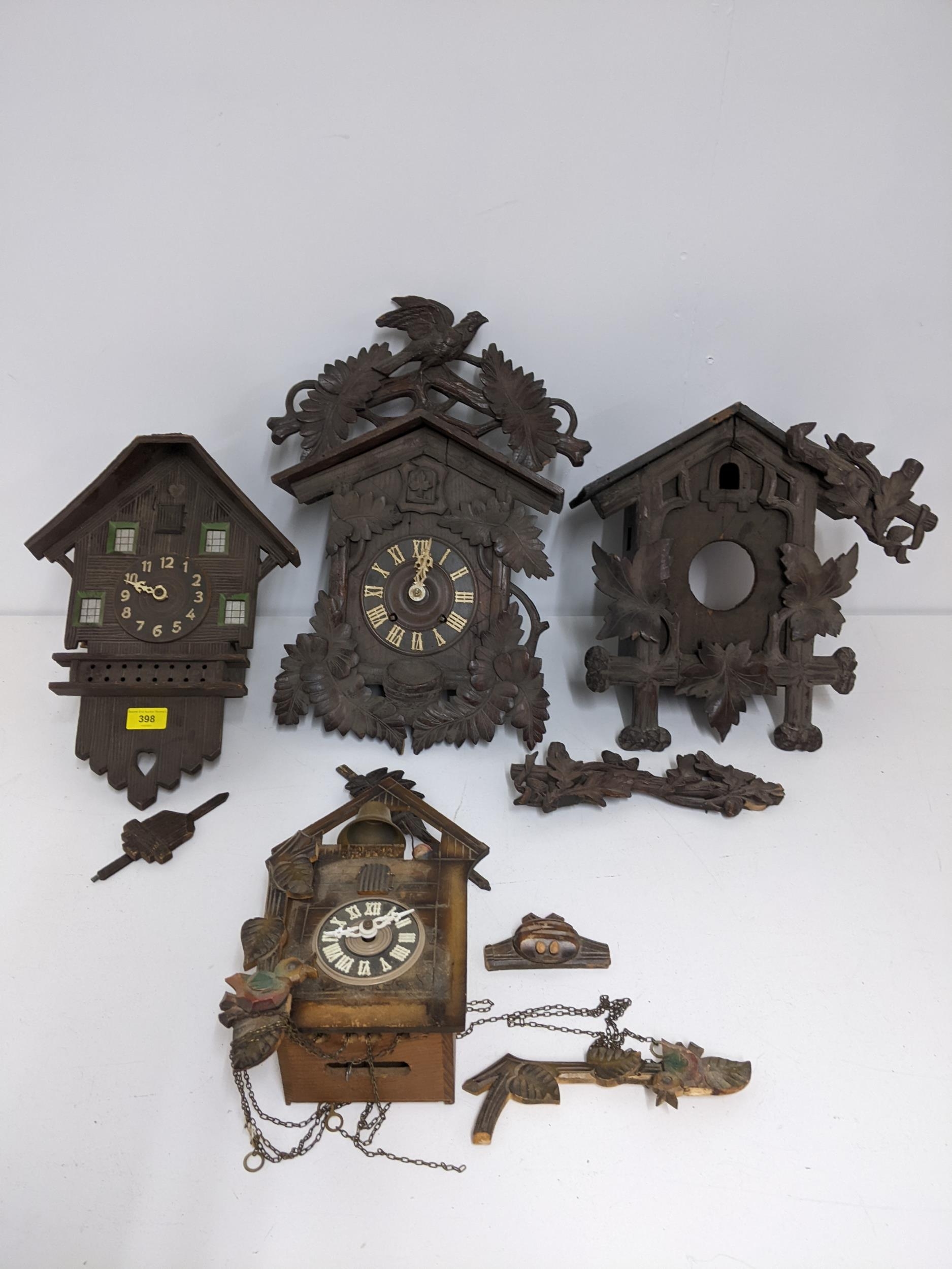 Four late 19th/early 20th century wooden cased cuckoo clocks, for repairs or spares Location: