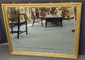 A large modern gilt framed mirror having a beaded border and bevelled glass, 100cm h x 130cm w