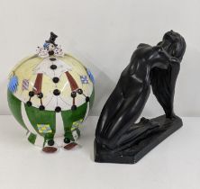 A 20th century plaster nude woman and a large money box fashioned as a clown Location: