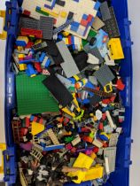A large quantity of loose Lego building blocks, and other Lego accessories in a big plastic box