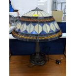 A Tiffany style lamp and shade decorated in white and blue with orange beading Location: