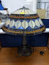 A Tiffany style lamp and shade decorated in white and blue with orange beading Location: