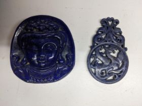 An Oriental carved lapis lazuli stone boulder, carved with a depiction of Buddha's head in relief,