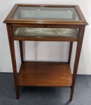 An Edwardian mahogany and boxwood inlaid display table having a hinged glazed top, shelf below and