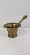 A bronze pestle and mortar with turned tapered body Location: