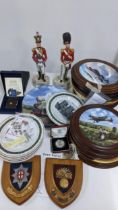 A mixed lot to include two porcelain models of soldiers, collectors plates, Royal Mint five pound