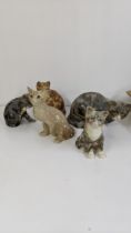 A group of seven Winstanley ceramic cats to include a Winstanley ginger cat with glass eyes, 21cm
