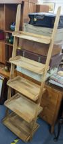 A modern light wood five tier ladder shelf unit, 177hx55w Location: