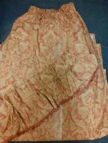 A pair of late 20th Century curtains in a salmon pink and gold Baroque style having a gathered