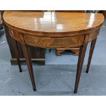 A George III mahogany fold over card table having string inlaid and on tapering legs 75hX93w