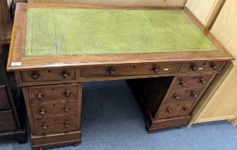 A Victorian walnut twin pedestal desk having a green leather top and nine drawers, 75h x 119.5w,