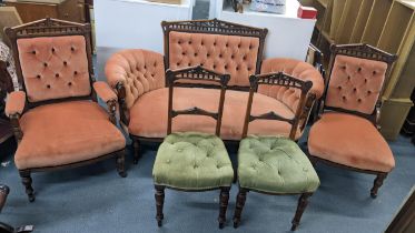 Circa 1900 a five piece walnut salon suite consisting of a sofa, two chairs and a pair of side