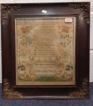 An 1833 framed and stretched sampler worked by Mary Bennett, the central verse being dedicated 'To