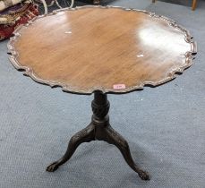 A Georgian mahogany tilt top occasional table in the Chippendale style having a turned column and