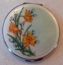 A 1960's/70's Birmingham white metal and enamelled compact with yellow daffodil design to the lid,