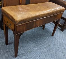 An early 20th century mahogany piano stool having a leather top and single drawer and pierced