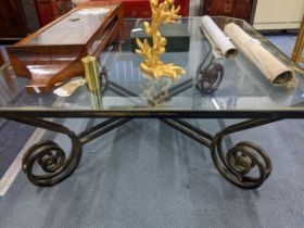 A contemporary glass topped and wrought iron coffee table 45x110x110cms Location: RAM