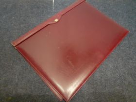 Gucci-A vintage burgundy leather desk pad having gold tone Gucci logo to the front and gilt embossed