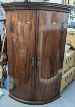 A Georgian mahogany bow fronted wall hanging corner cabinet 111cm h x 73.5cm w