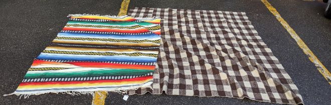 One blanket decorated in a crown and brown lattice pattern and multicoloured Navoh flat wool Kelim