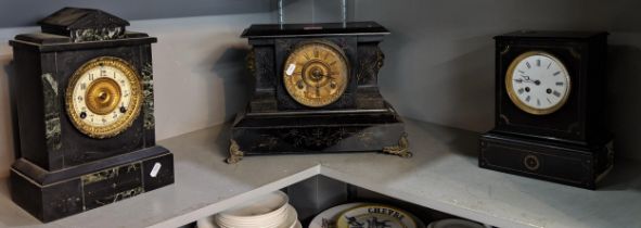 Three black slate mantle clocks of architectural form, in need of restoration, to include one with