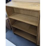 A collection of light oak finished open bookcase to include two tall bookcases and three smaller