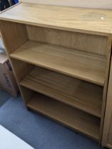 A collection of light oak finished open bookcase to include two tall bookcases and three smaller