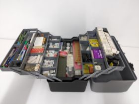 A box containing various artist's paints, inks, pen nibs, chalks, crayons and other accessories