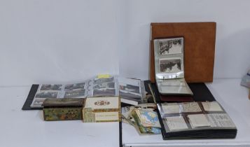 A collection of vintage postcards to include two albums and some loose, along with an album filled