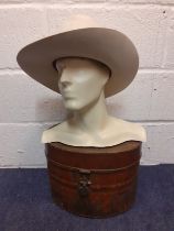 A vintage male mannequin head and shoulders with chiselled features in cream together with a 1920'