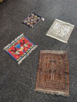 Four mats to include one Chinese, one Kelim one Baluch and one silk decorated with the Tree of