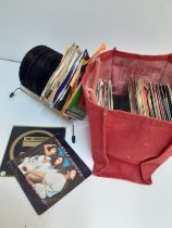 A quantity of 45rpm single records to include Paul Hardcastle together with a vintage table top