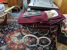 An Aman Marseille porcelain headed doll and two modern dolls and a Silver Cross dolls pram