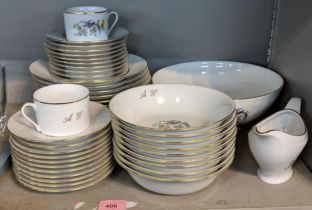 A part porcelain Limoges dinner service to include a serving bowl, a sauce/gravy boat, two cups,