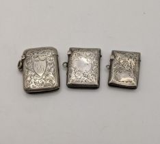 Three silver vesta cases, all having floral engraved detail, to include one dated Birmingham 1905,