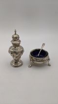 Two silver condiments to include a salt and an embossed pepper pot, total weight excluding glass