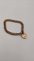 A 9ct rose gold curb link bracelet having a heart shaped clasp 14g Location: