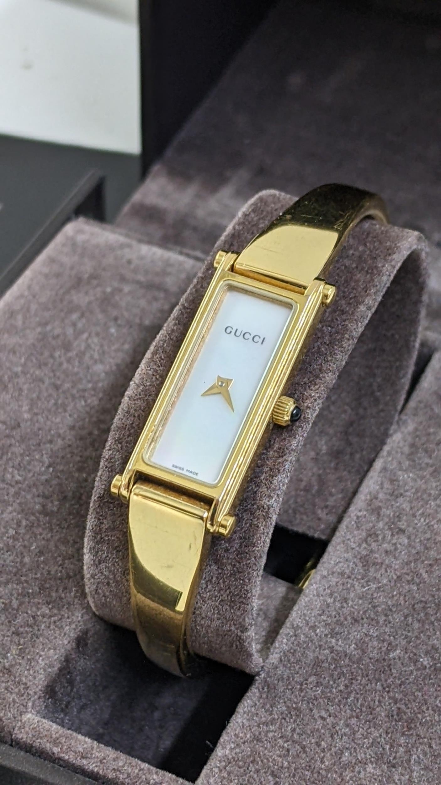 A boxed Gucci gold plated bangle wristwatch with a mother of pearl dial Location: - Image 2 of 2