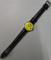 A Snoopy tennis unisex wristwatch with a quartz movement, yellow face, Arabic and baton dials on a