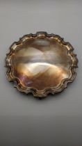 A silver three-footed card tray having serpentine border hallmarked London 2000, 355.6g Location: