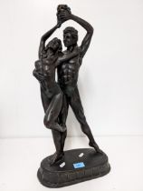 An Academy bronzed patinated composition sculpture of two figures in a dancing pose, label to