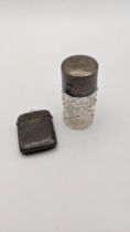 A silver topped scent bottle, together with a silver vesta case Location: