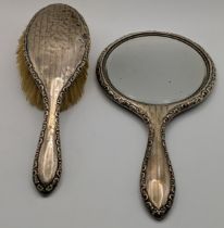 A silver backed hairbrush and hand mirror Location: