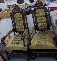 A pair of late 19th century carved oak throne style chairs with barley twist columns and tapestry