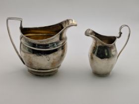 Two silver jugs, one bearing indistinct marks, the other marked London 1915, 246.5g Location: