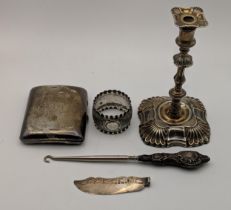 Silver items to include a candlestick, a knife blade, a cigarette case, a silver handled button hook