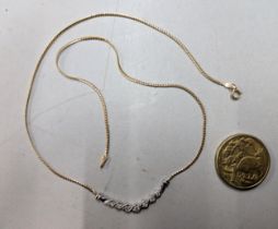 A 9ct yellow and white gold necklace inset with seven diamonds 3.9 grams together with a 1985